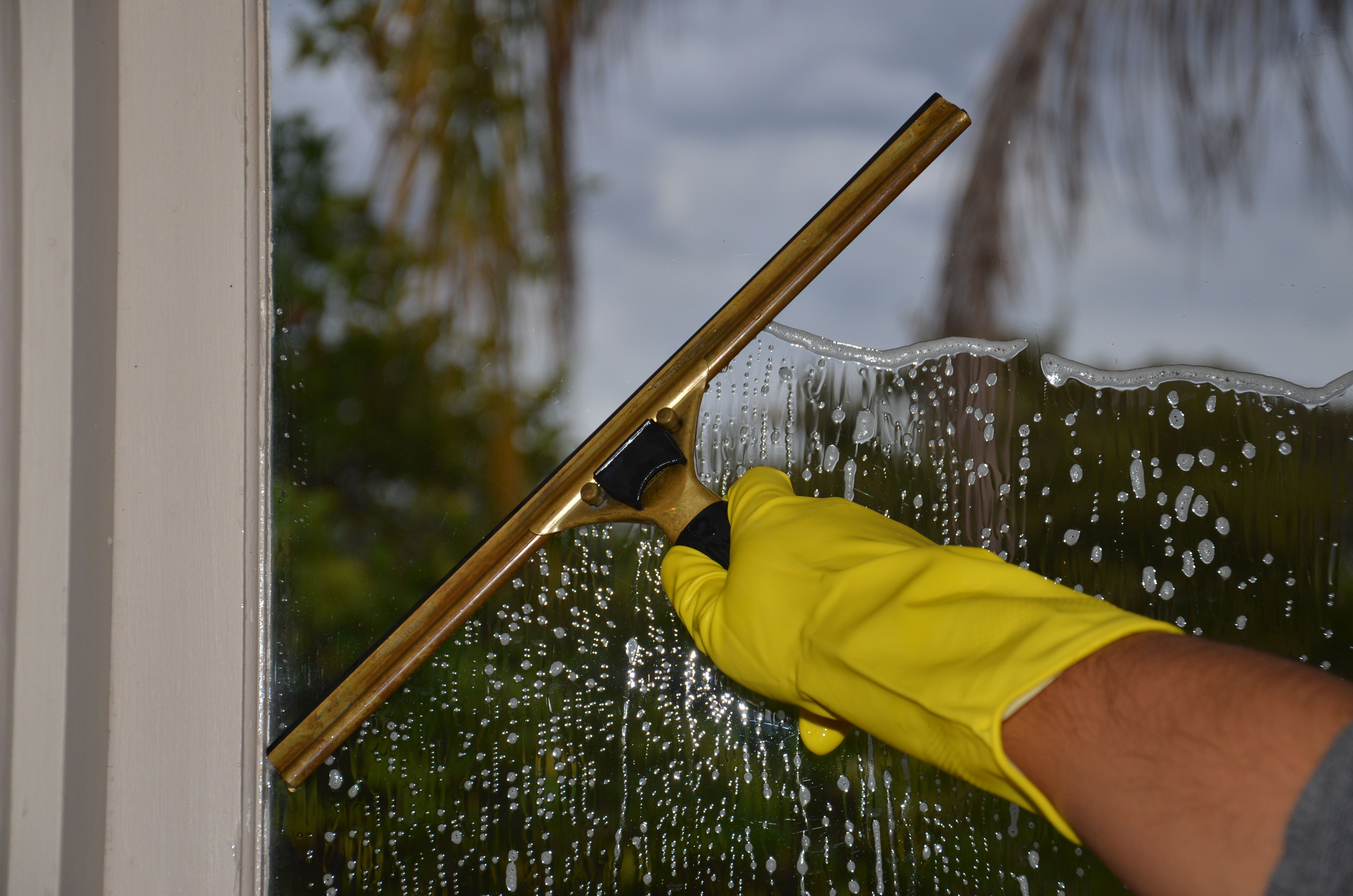 Squeegee cleaning a window at a home in Anaheim